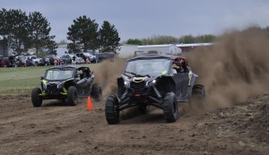 Driver create a dust storm as the charge down the 300 foot strip in neck and neck competition